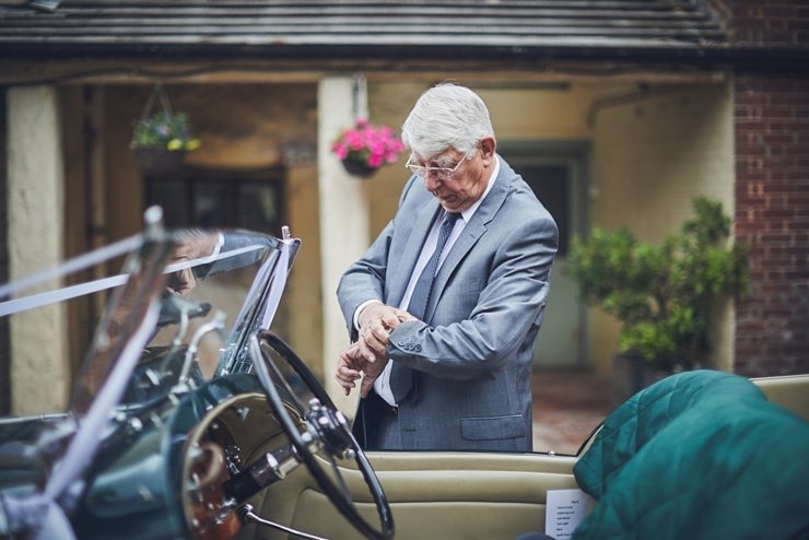 father of the bride check his watch before the wedding in Devon