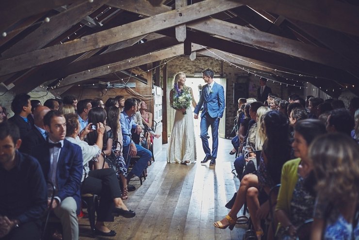 guests holding hands at humanist ceremony at East Soar in Devon