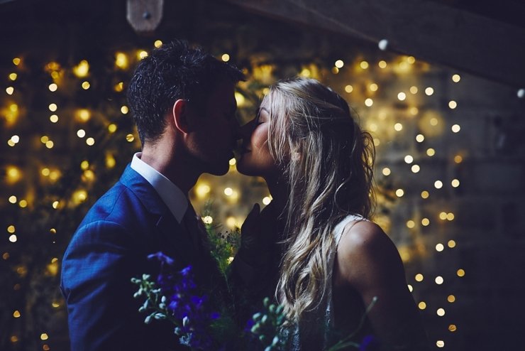 guests holding hands at humanist ceremony at East Soar in Devon