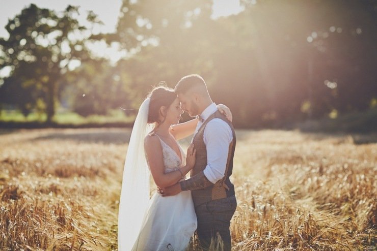 couple in the cornfield at summer wedding in Devon
