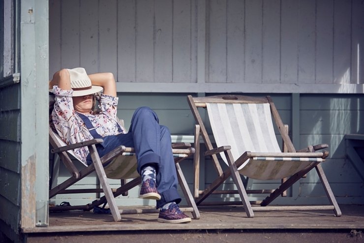 guest relaxing on a deckchair at a Devon wedding at Hallsannery