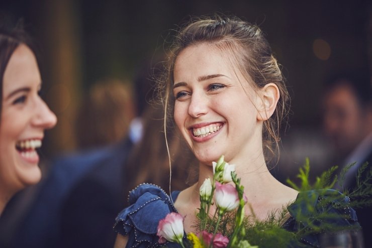 guests holding hands at humanist ceremony at East Soar in Devon