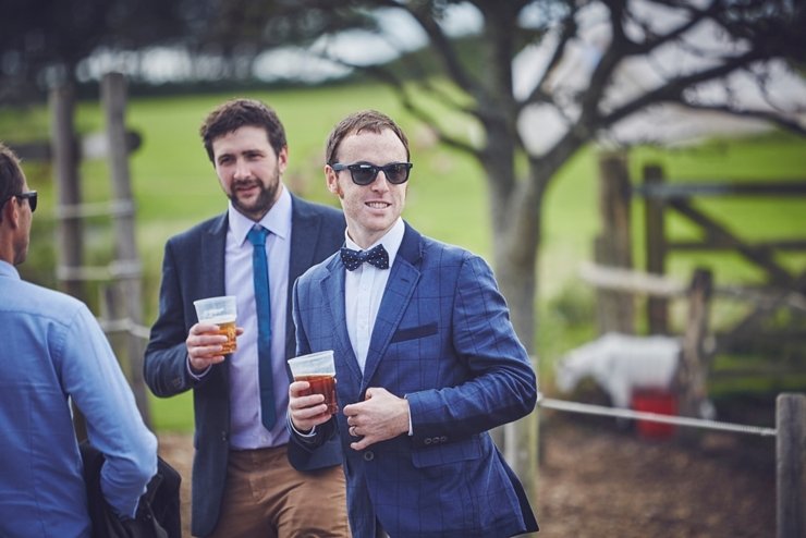 guests holding hands at humanist ceremony at East Soar in Devon