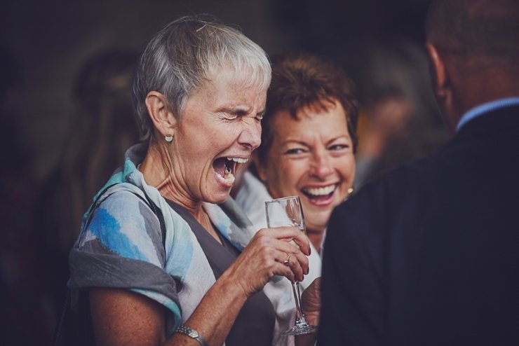 guests holding hands at humanist ceremony at East Soar in Devon
