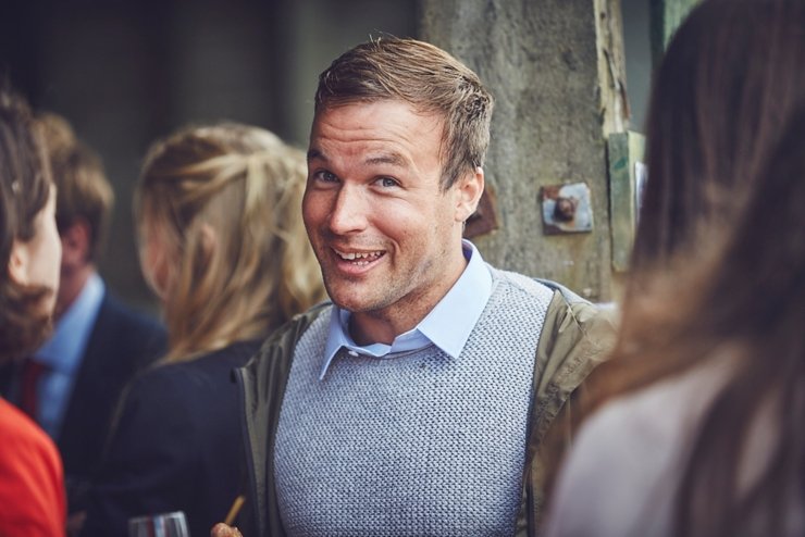 guests holding hands at humanist ceremony at East Soar in Devon