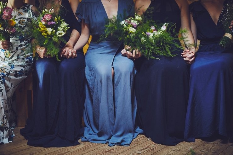 guests holding hands at humanist ceremony at East Soar in Devon