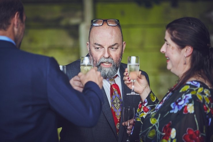 guests holding hands at humanist ceremony at East Soar in Devon