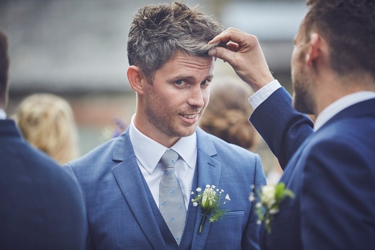 guests holding hands at humanist ceremony at East Soar in Devon